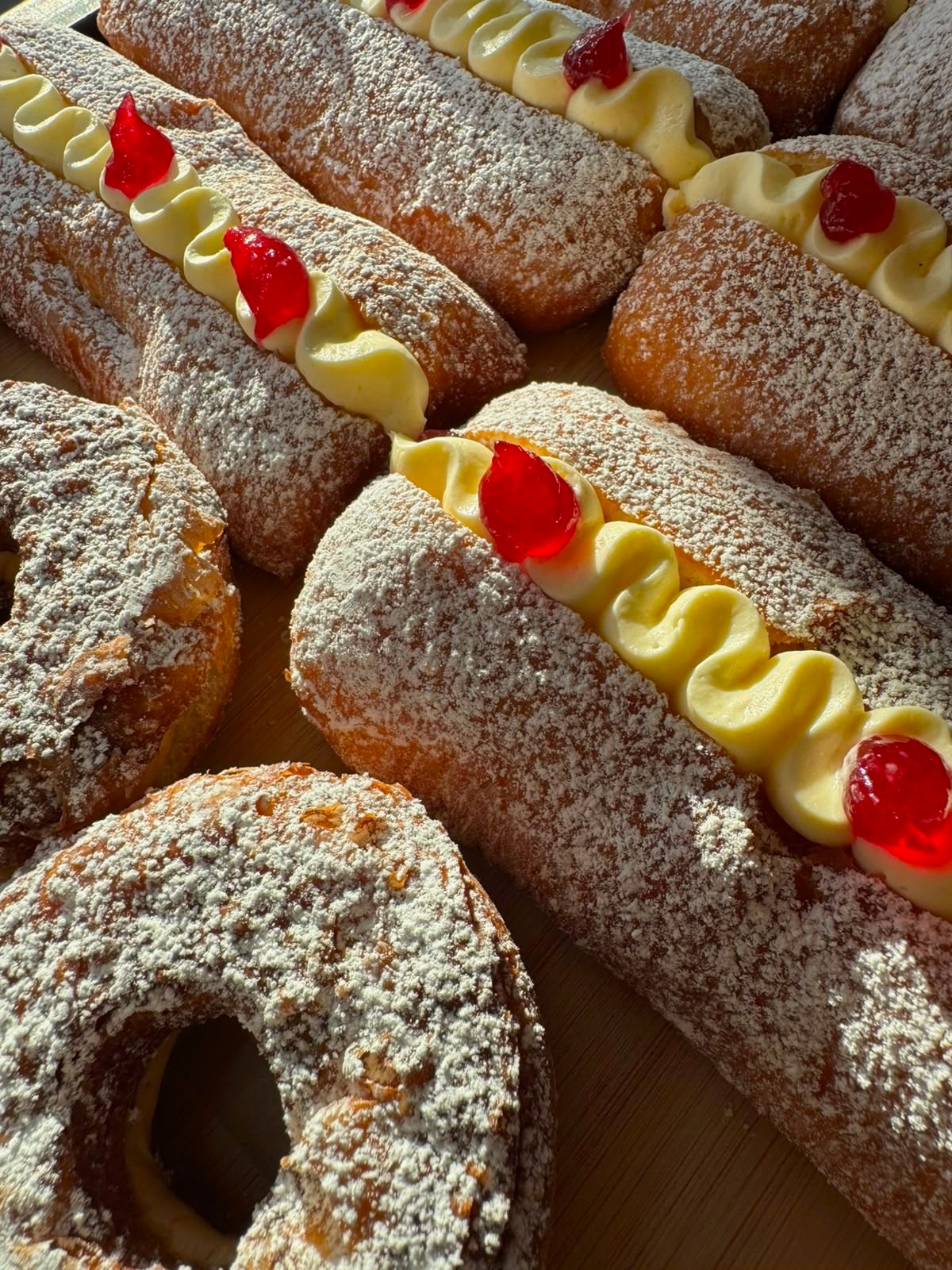Fresh cream buns finished with custard and raspberry jam